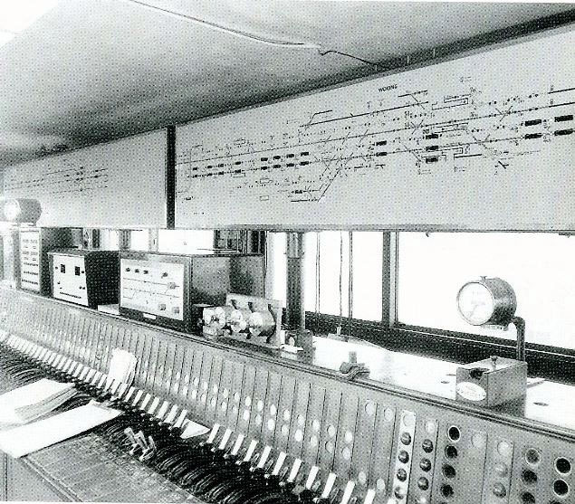 Woking signal box internior taken post 1967, with its Westinghouse Brake and Signal Co. Ltd miniature power lever frame, notice the train describers in the diagram, and the NX Panel for Brookwood in the down direction.